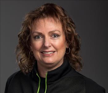 Female Employee in front of a grey backdrop 